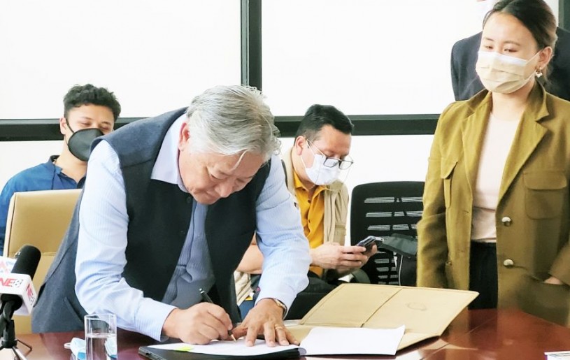 IDAN CEO Alemtemshi Jamir signing the MoU on September 10. (Morung Photo)